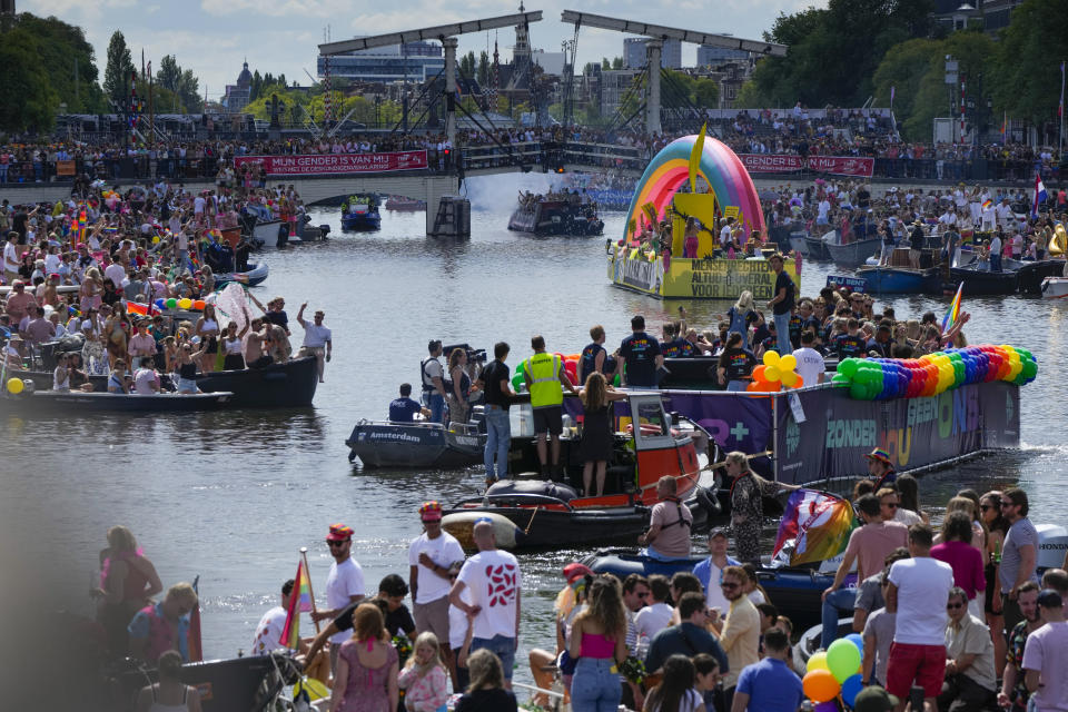 Hundreds of thousands of people lined canals in the Dutch capital to watch the colorful spectacle of the Pride Canal Parade return for the 25th edition after the last two events were canceled due to the COVID-19 pandemic, in Amsterdam, Netherlands, Saturday, Aug. 6, 2022. (AP Photo/Peter Dejong)