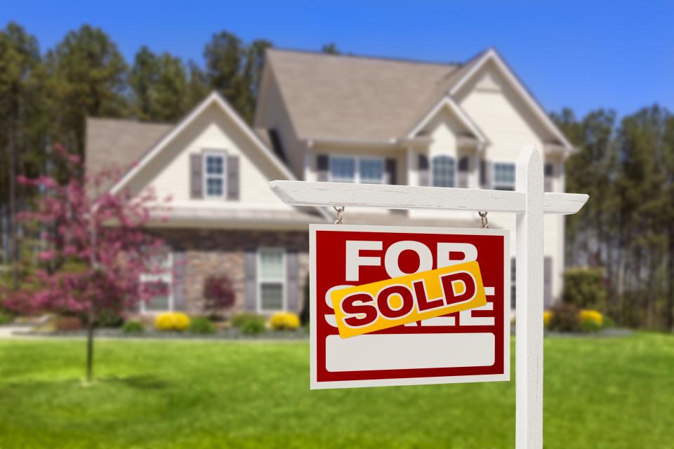FILE PHOTO FROM GETTY IMAGES Sold Home For Sale Real Estate Sign and House
