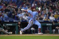 Philadelphia Phillies' Alec Bohm follows through after hitting a home run off of Pittsburgh Pirates' Jared Jones during the fourth inning of a baseball game, Thursday, April 11, 2024, in Philadelphia. (AP Photo/Matt Rourke)