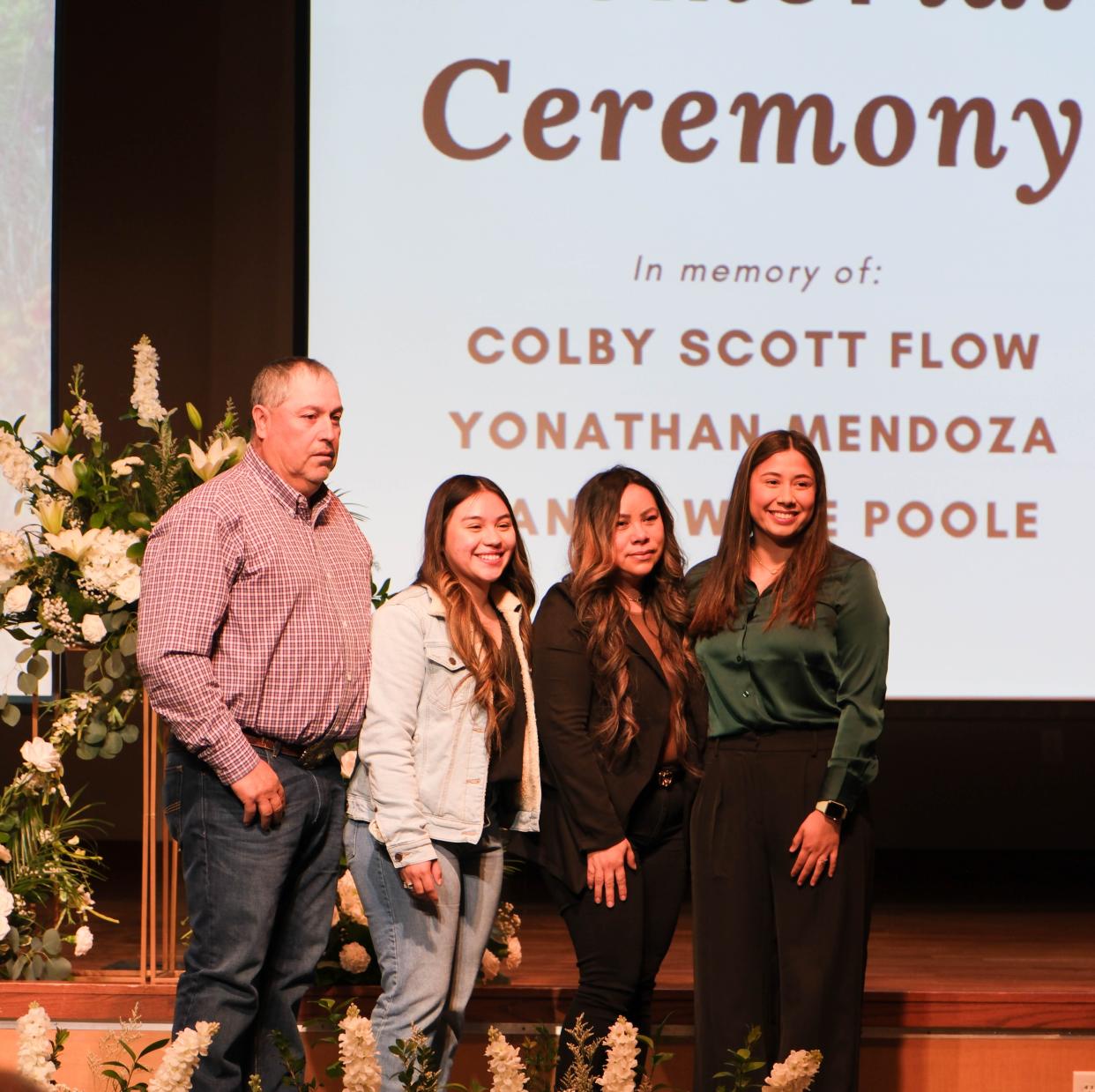 The family of Yonathon Mendoza stand with the Ximena Badillo, the recipient of a scholarship in his name Friday at a student memorial service at West Texas A&M in Canyon.