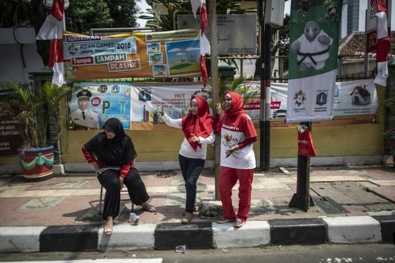 Indonesian women watch from the sidelines