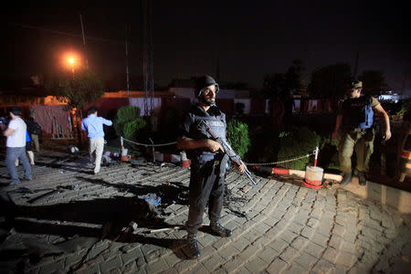 A policeman stands guard after a blast in Lahore, Pakistan August 7, 2017. REUTERS/Mohsin Raza