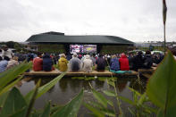 Spectators on the Hill watch the action on the giant screen, on day two of the Wimbledon tennis championships in London, Tuesday, July 4, 2023. (Steven Paston/PA via AP)