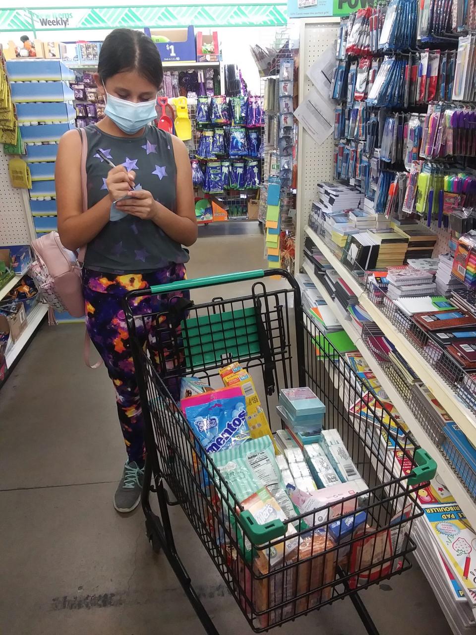 Skyla Marroquin picks up supplies. (Photo: April Guajardo)