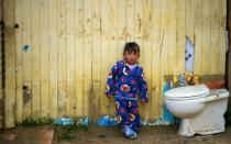 A Colombian boy stands in the El Ensueno neighborhood of the Ciudad Bolivar slum on the edge of Bogota -- 18 months after the government signed a peace deal with FARC rebels, the poor still languish on society's margins