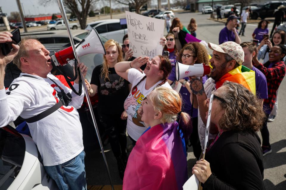 An anti-LGBTQ protester, left, who declined to give his name is confronted on Feb. 26 across the street from Owasso High School during a planned student walkout in response to the death of Nex Benedict in Owasso.