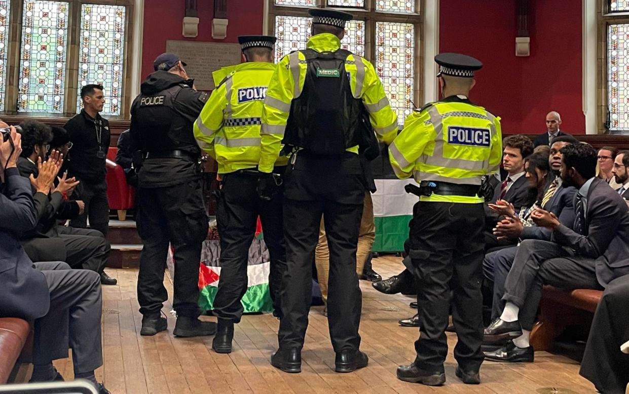 Police remove two pretesters from the event