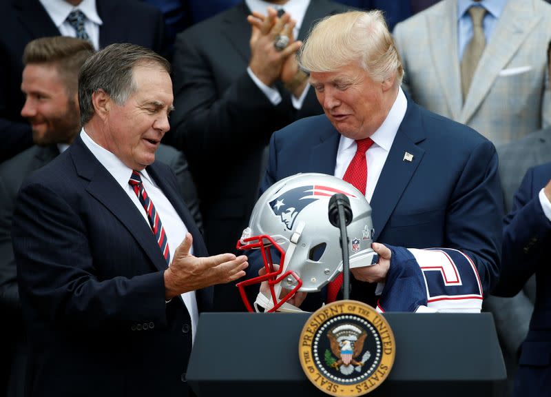 U.S. President Donald Trump holds a New England Patriots helmet as Coach Bill Belichick and CEO of the New England Patriots Robert Kraft, watch during an event honoring the Super Bowl champion team at the White House in Washington