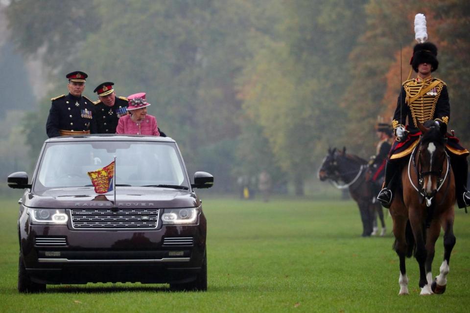 Queen Elizabeth is driven along in a state review Land Rover. (REUTERS)