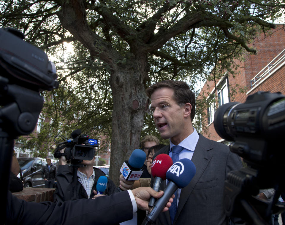 Dutch Prime Minister and Liberal Party leader Mark Rutte is interviewed after casting his ballot for parliamentary elections in The Hague, Netherlands, Wednesday Sept. 12, 2012. (AP Photo/Peter Dejong)