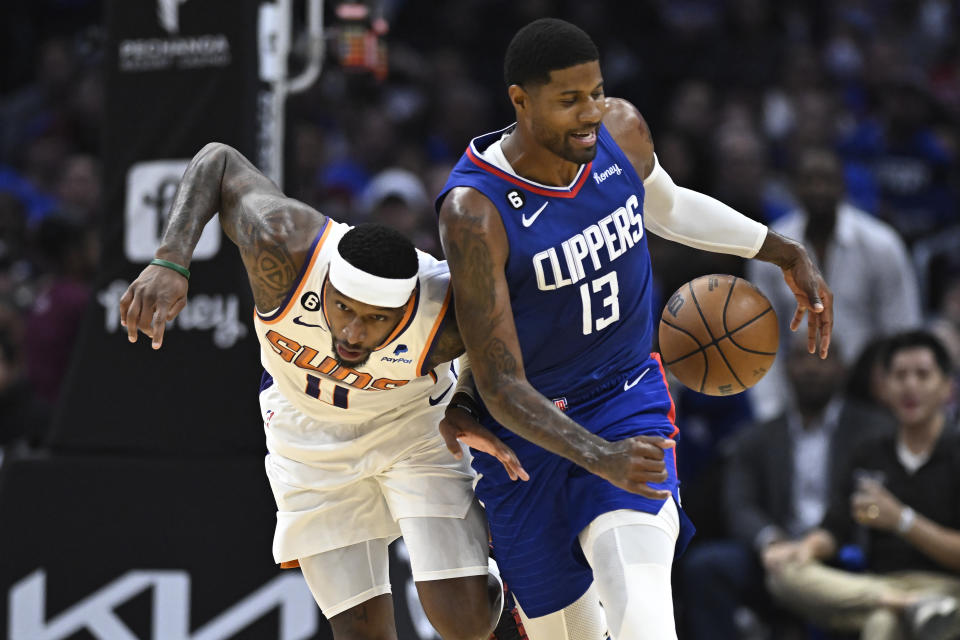 Phoenix Suns center Jock Landale, left, bumps into Los Angeles Clippers guard Paul George during the second half of an NBA basketball game, Sunday, Oct. 23, 2022, in Los Angeles. (AP Photo/Alex Gallardo)