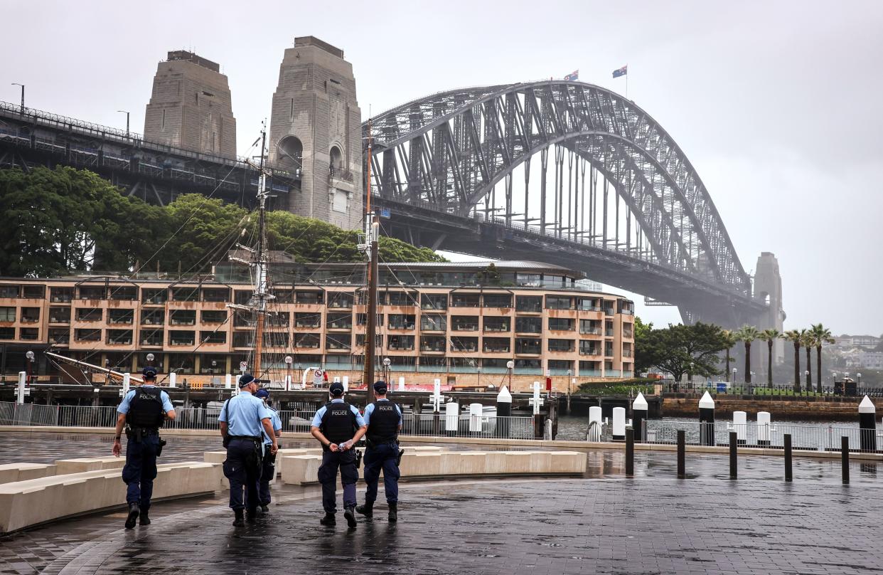 New South Wales police officers patrol an area in front of the Harbour Bridge  in central Sydney on 31 December, 2020. Police are investigating after a group of Sikh men were attacked in a vehicle. (AFP via Getty Images)