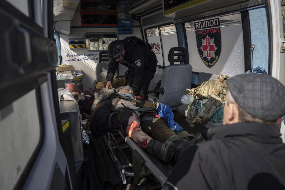 A Ukrainian police officer of the White Angels unit, loads an injured woman on a stretcher into a van after shelling by Russian forces, during her evacuation to a hospital in Kostiantynivka, Ukraine, Friday, March 10, 2023. For months, authorities have been urging civilians in areas near the fighting in eastern Ukraine to evacuate to safer parts of the country. But while many have heeded the call, others -– including families with children -– have steadfastly refused. (AP Photo/Evgeniy Maloletka)