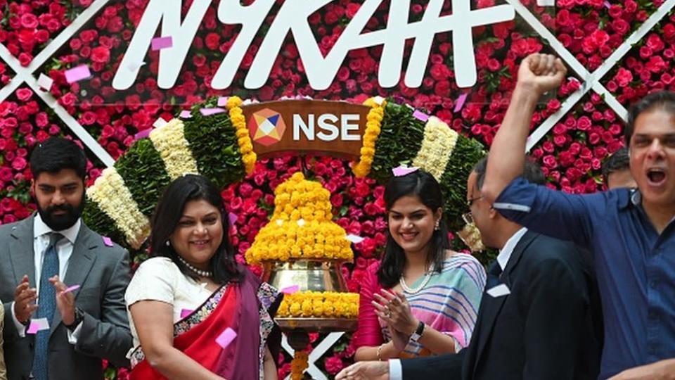 Falguni Nayar (CL), managing director and CEO of Nykaa, along with her daughter Advaita (CR) attends the company's IPO listing ceremony at the National Stock Exchange in Mumbai on November 10, 2021