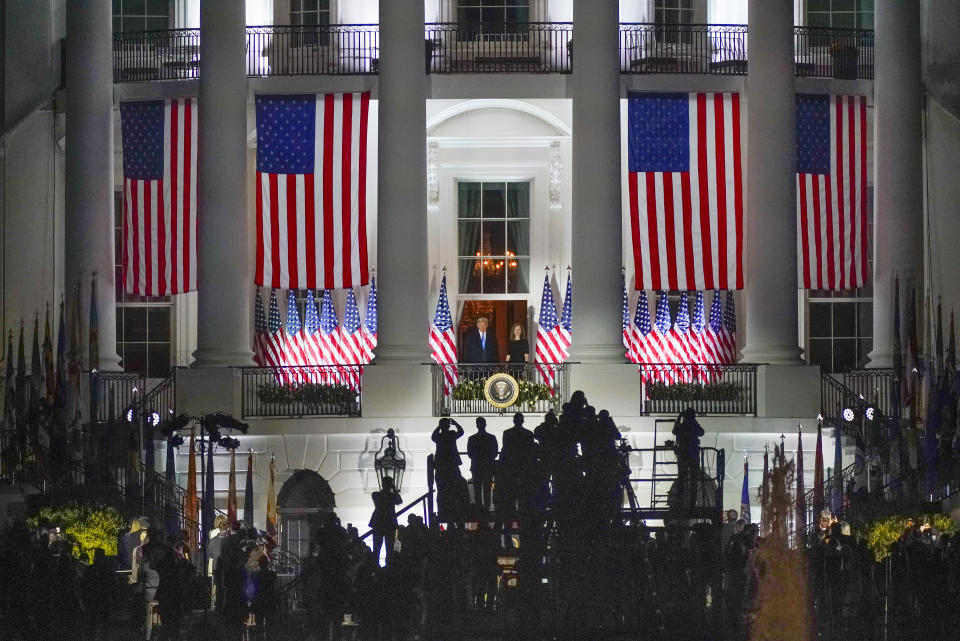 President Donald Trump and Amy Coney Barrett stand on the Blue Room Balcony after Supreme Court Justice Clarence Thomas administered her the Constitutional Oath on the South Lawn of the White House in Washington, Monday, Oct. 26, 2020. (AP Photo/Carolyn Kaster)