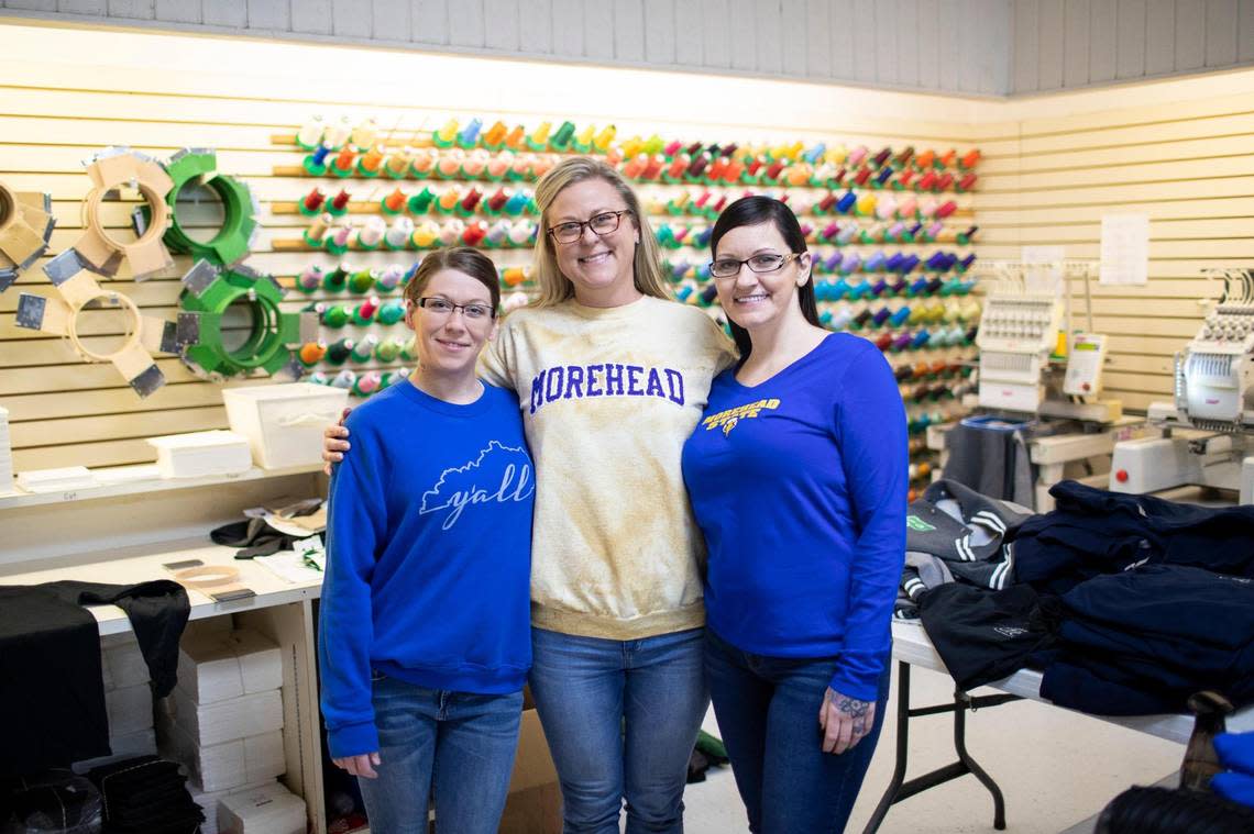 Brandy Moore (left) and Deidra Stearns with Kari Flanders (center) the owner of Holbrook’s Embroidery Plus in Morehead, Ky., on Tuesday, November 22, 2022.