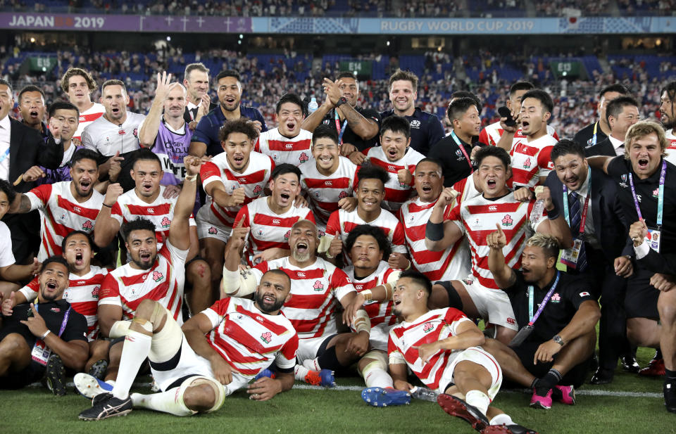 Japan players and management celebrate after defeating Scotland 28-21 in their Rugby World Cup Pool A game at International Stadium in Yokohama, Japan, Sunday, Oct. 13, 2019. (AP Photo/Christophe Ena)