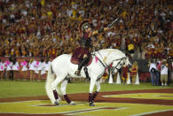 File-Hector Aguilar rides Traveler VII during the second half of an NCAA college football game between Southern California and Utah, Saturday, Oct. 24, 2015, in Los Angeles. Southern Cal's famed white horse, Traveler, won't be galloping triumphantly after a Trojans touchdown. From Ann Arbor to Los Angeles to Oxford, that most American of pursuits, college football, has either given up hope of getting in a traditional season or is flinging what amounts to a Hail Mary pass in a desperate attempt to hang on in the age of Covid-19. (AP Photo/Mark J. Terrill, File)