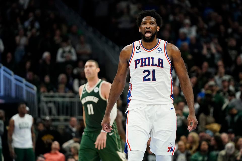 Joel Embiid reacts after making a basket.