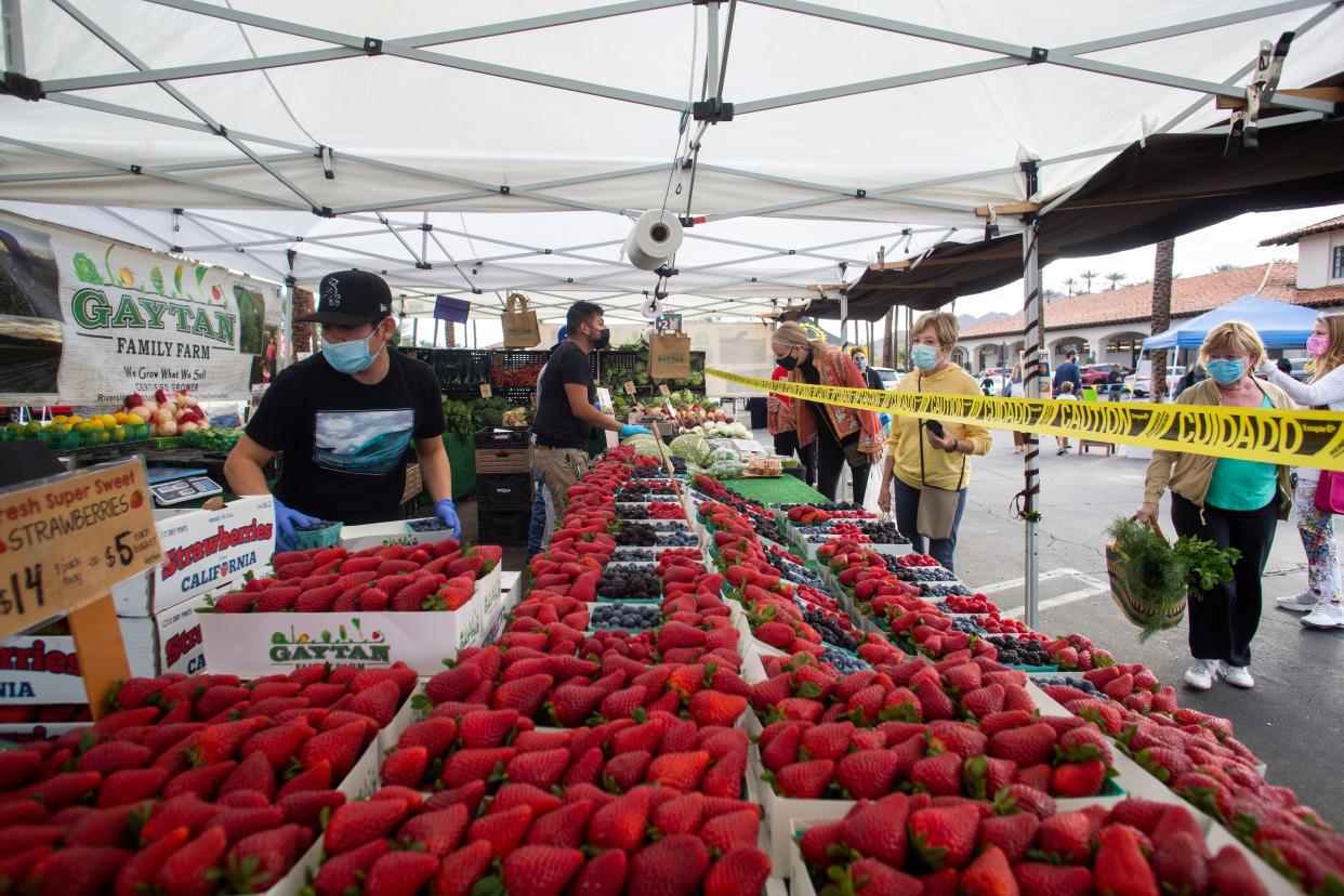 Shoppers buy fresh produce at the Indian Wells Farmer's Market at the Village shopping center on January 21, 2020. The Certified Farmers Market offers a variety of products including organic poultry, fish and vegetables. 