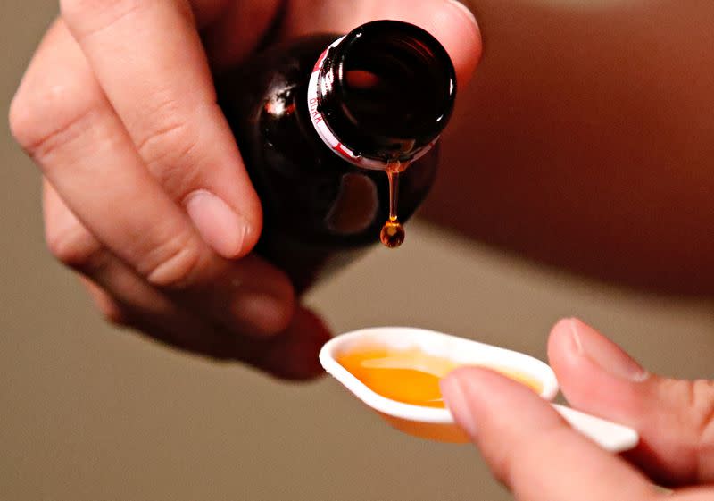 FILE PHOTO: A cough medication is poured in this picture illustration