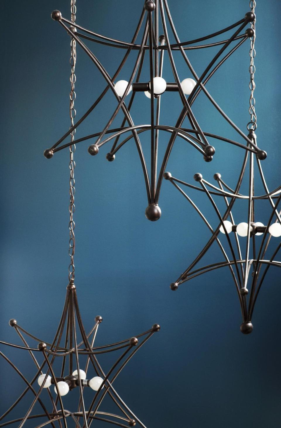 This undated publicity photo provided by Brian Patrick Flynn shows the clean lines of this geometric metal pendant light by Crystorama that works well with many different styles of interior design, used here in an entryway by Designer Brian Patrick Flynn. Open pendant lights can showcase interesting light bulbs and serve as a striking piece of decor for a home's entryway. (AP Photo/Brian Patrick Flynn, Sarah Dorio/Scripps Networks Interactive)