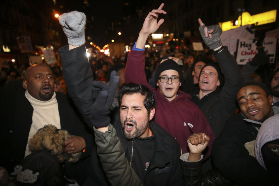 Protestors march against a grand jury's decision not to indict the police officer involved in the death of Eric Garner, Thursday, Dec. 4, 2014, in New York. A grand jury cleared a white New York City police officer Wednesday in the videotaped chokehold death of Garner, an unarmed black man, who had been stopped on suspicion of selling loose, untaxed cigarettes, a lawyer for the victim's family said. (AP Photo/John Minchillo)