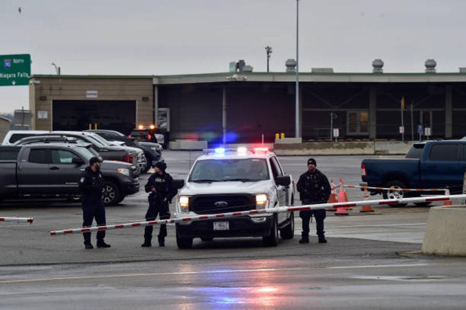 Police stand guard as the Peace Bridge, one of four major crossings into the US from Canada, is closed after a car crashed and exploded at The Rainbow Bridge on 22 November 2023 (Getty Images)