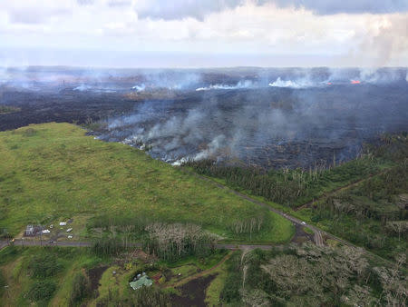 An aerial view shows an active lava flow crossing Pohoiki Road during ongoing eruptions of the Kilauea Volcano in Hawaii, U.S. May 28, 2018. Picture taken May 28. 2018. USGS/Handout via REUTERS