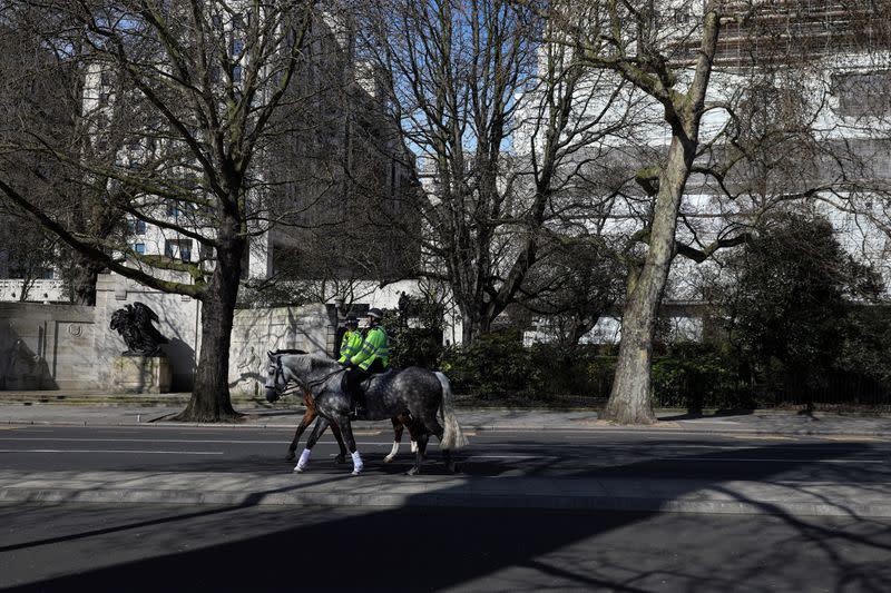 Mounted police ride along the Victoria Embanlment