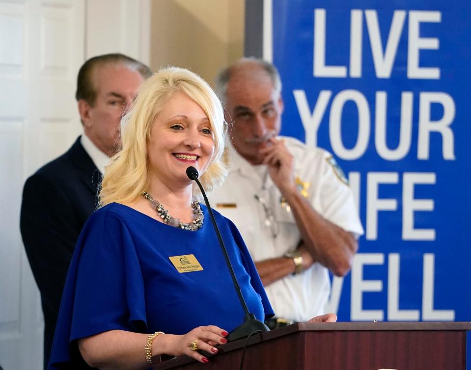 Barbara Ann Heegan, president and CEO of the Port Orange South Daytona Chamber of Commerce, speaks at a lunchtime forum at Riverside Pavilion in Port Orange on Thursday, April 11, 2024. The topic was the growing opioid epidemic. Pictured behind Heegan are state Sen. Tom Wright and Volusia County Sheriff Mike Chitwood.