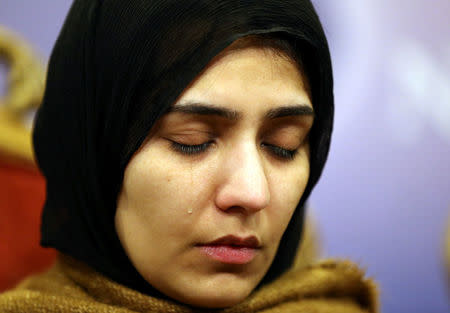 FILE PHOTO - Mesha Saeed, wife of missing social activist Waqass Goraya, sheds a tear during a final prayer at the end of a news conference held by social activists and family members of missing social activists in Islamabad, Pakistan January 18, 2017. REUTERS/Caren Firouz/File Photo