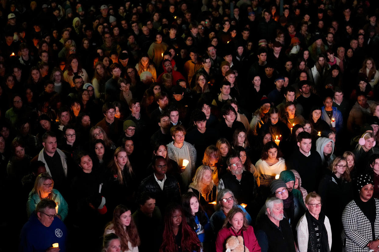 People gather at a vigil for the victims of Lewiston's mass shootings. (Matt Rourke / AP)