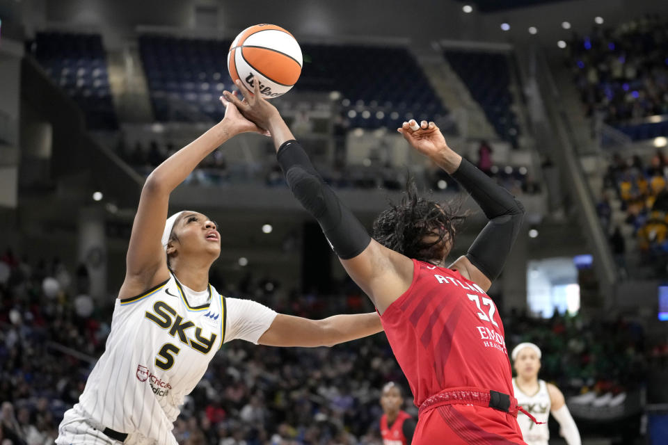 Chicago Sky's Angel Reese (5) taps the ball away from Atlanta Dream's Cheyenne Parker-Tyus on a pass intended for Parker-Tyus during the second half of a WNBA basketball game Wednesday, July 10, 2024, in Chicago. The Sky won 78-69. (AP Photo/Charles Rex Arbogast)