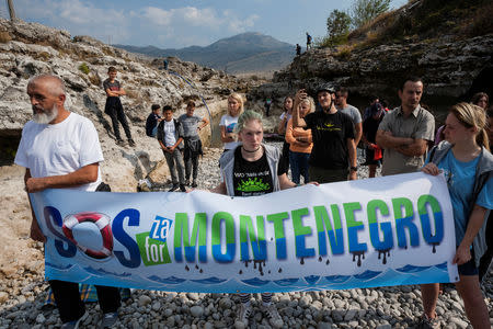 Environmental activists protest in the dried out riverbed of Cijevna River in Dinosa village, near Tuzi, Montenegro October 20, 2018. REUTERS/Stevo Vasiljevic