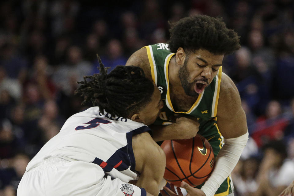 Gonzaga guard Hunter Sallis, left, collides with and fouls San Francisco forward Isaiah Hawthorne during the second half of an NCAA college basketball game, Thursday, Feb. 9, 2023, in Spokane, Wash. (AP Photo/Young Kwak)