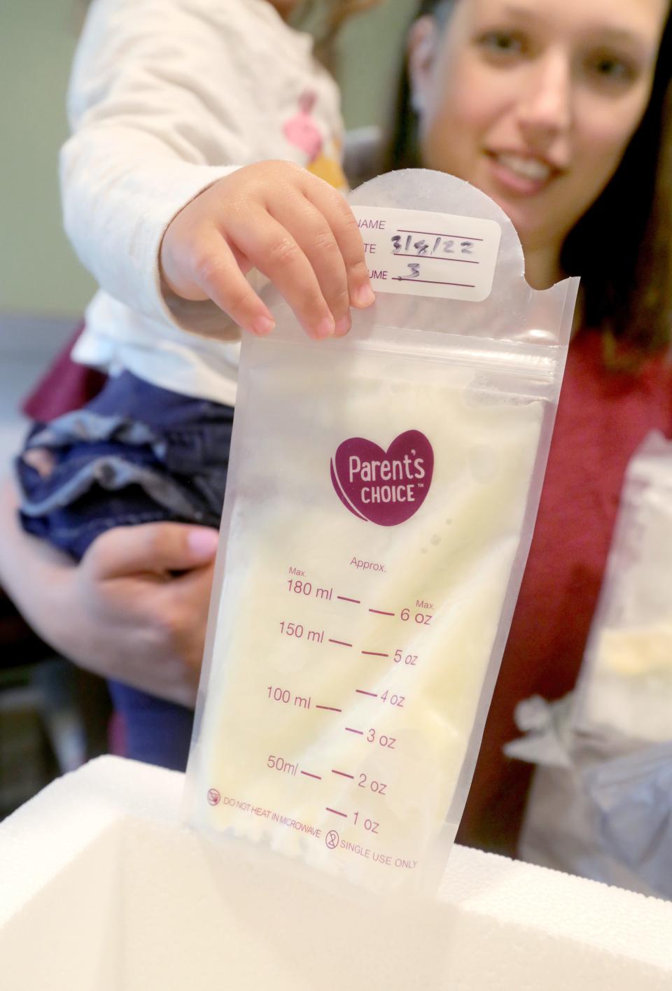 Maddie Sponsler gets help from her daughter Katelynn, 20 months, with packing bags of breast milk to send to OhioHealth Mothers' Milk Bank on Monday in Wadsworth.