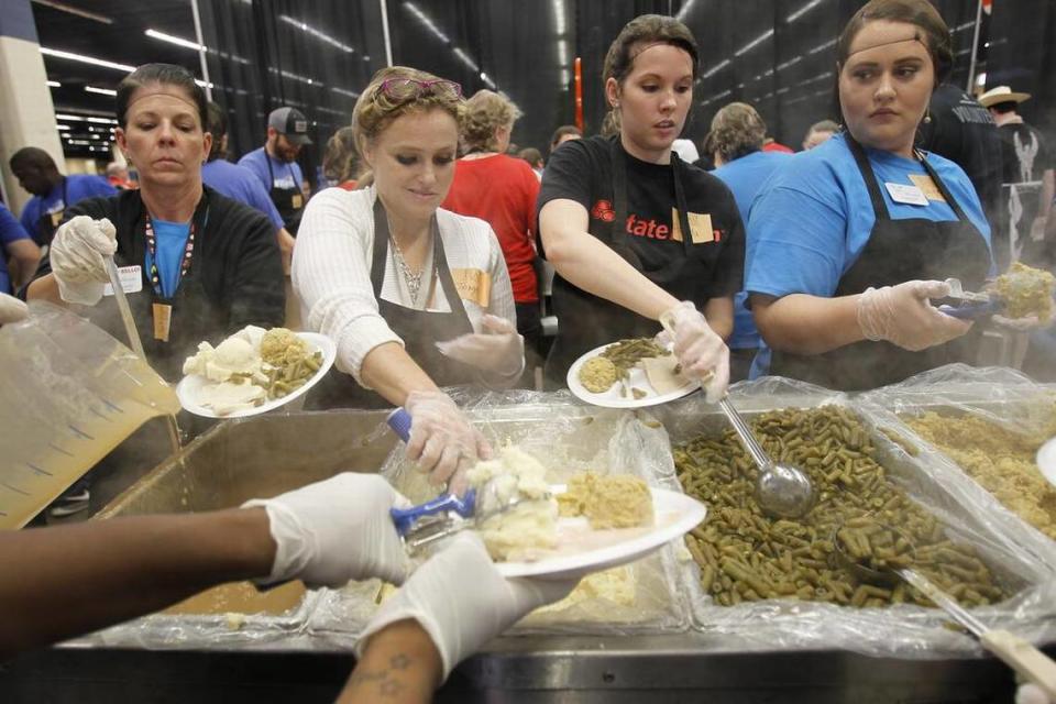 Volunteers Jennifer Lewis, left, Tanya Griebe, Amanda Bray and Sage Bevan prepare food during the H-E-B/Central Market Feast of Sharing at Will Rogers Memorial Center in Fort Worth on Tuesday, Nov. 10, 2015. Khampha Bouaphanh/Star-Telegram