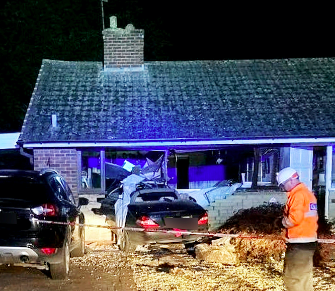 The car was completely embedded in the lounge at the front of the house. (SWNS)