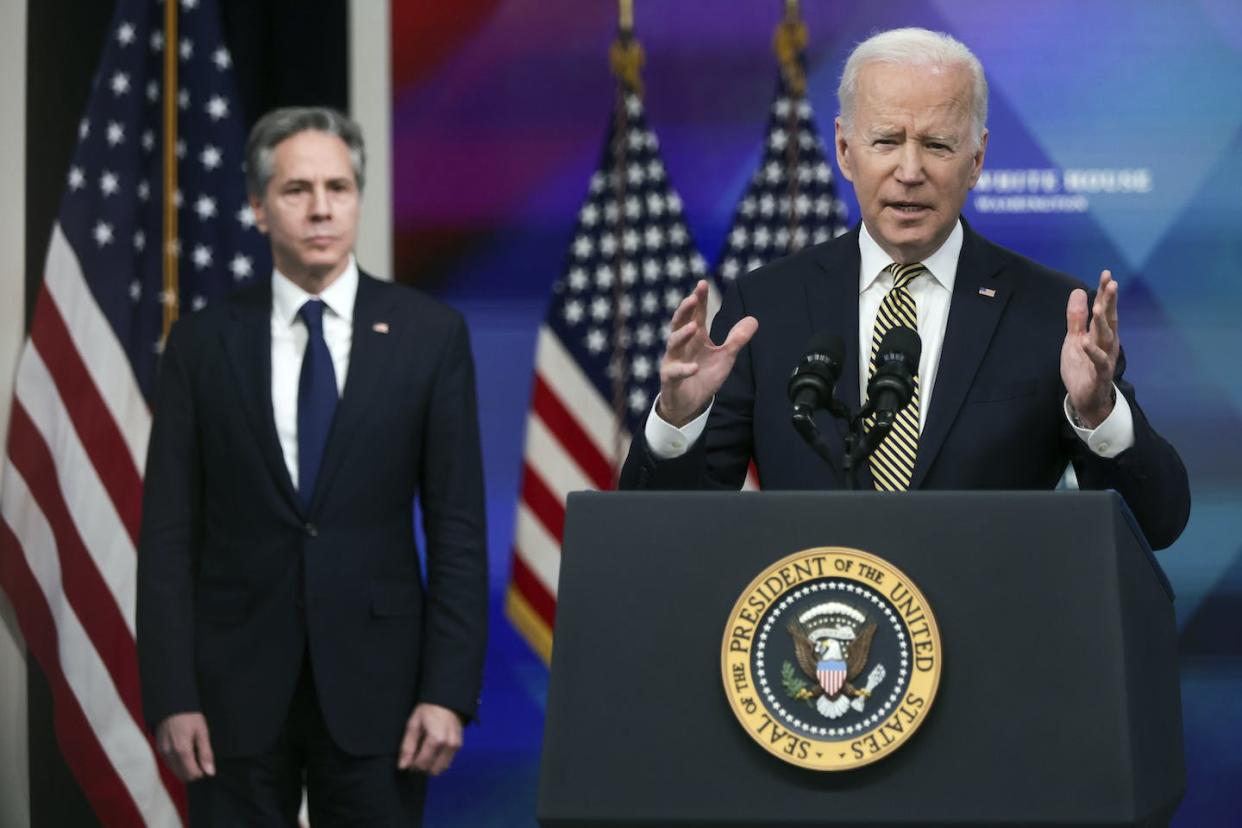 President Joe Biden speaks as Secretary of State Antony Blinken looks on. Photo by Alex Wong/Getty Images