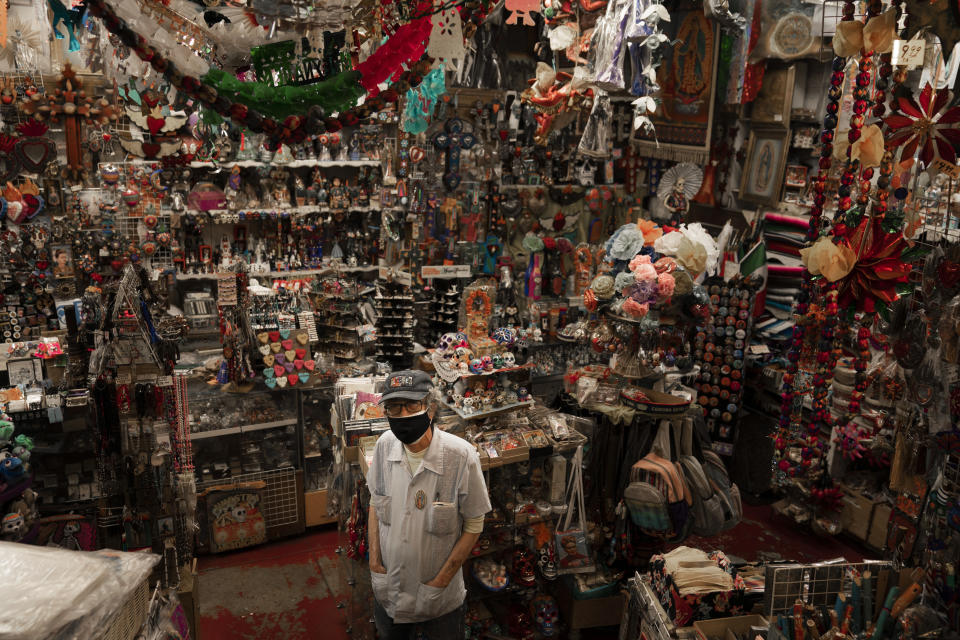 Mike Mariscal, owner of Myrosa Enterprises souvenir shop on Olvera Street, stands for a photo in his store in Los Angeles, Friday, June 4, 2021. “People are just now getting out. We’re not the first destination. There will be some people who stay away. No one’s every been through this before. Nobody really knows. Some people are going to have that fear,” said Mariscal. (AP Photo/Jae C. Hong)