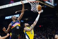 Phoenix Suns center Bismack Biyombo (18) jumps up to block a shot by Indiana Pacers forward Oshae Brissett (12) during the first half of an NBA basketball game Saturday, Jan. 22, 2022, in Phoenix. (AP Photo/Ross D. Franklin)