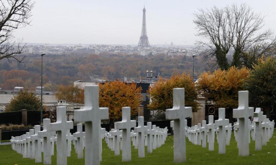 The Eiffel Tower looms in the background of the headstones during a commemoration ceremony at Suresnes cemetery.