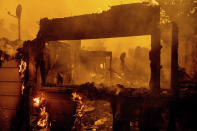 Flames consume an Oakmont neighborhood home as the Glass Fire burns in Santa Rosa, Calif., Monday, Sept. 28, 2020. (AP Photo/Noah Berger)