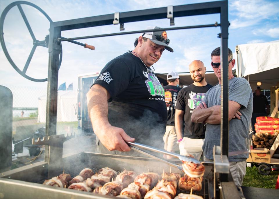 Scenes from the 3 Taxi Guys team grill during the annual Memphis in May World Championship Barbecue Cooking Contest at Tom Lee Park on Wednesday May 12, 2021.