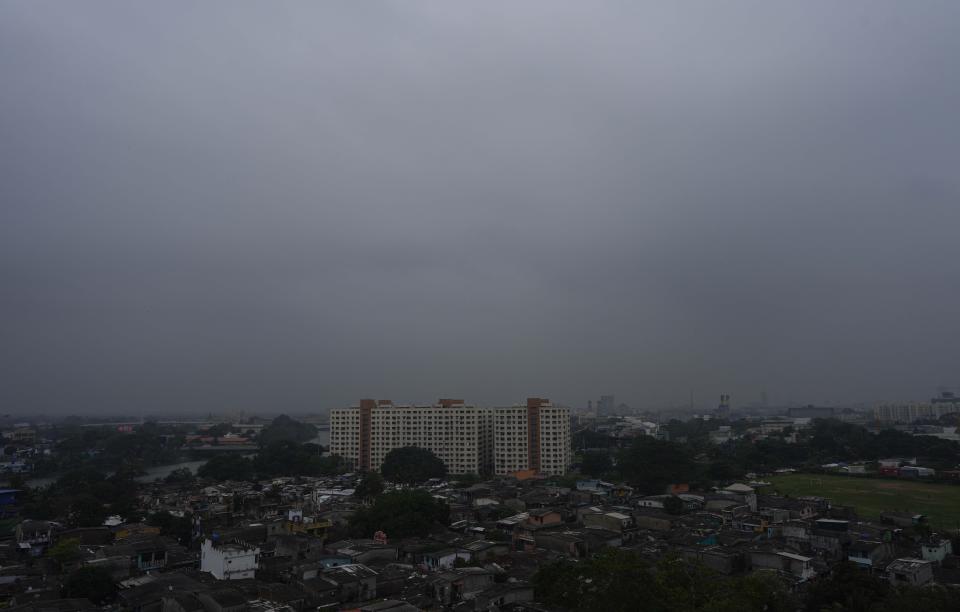 Smog and fog envelop the skyline in Colombo, Sri Lanka, Friday, Dec. 9, 2022. Schools across Sri Lanka were closed on Friday as health and environment officials said air quality was unhealthy in most parts of the island nation partly due to extreme weather conditions. (AP Photo/Eranga Jayawardena)