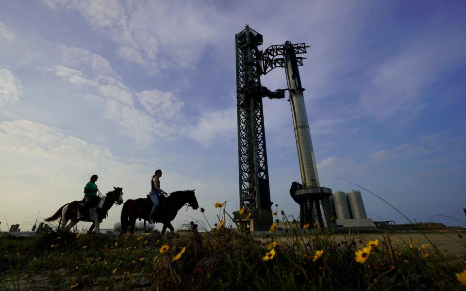 NASA astronauts Sunita Williams and Haley Esparza ride past SpaceX&#39;s Starship on the launchpad in Boca Chica, Texas - Eric Gay/AP