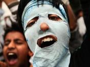 A masked Kashmiri shouts slogans during a protest at Barthana neighborhood in Srinagar, India, Wednesday, Aug. 4, 2010. Relative calm prevailed in the restive Indian-controlled portion of Kashmir Wednesday after days of violent clashes between troops and Kashmiri Muslims but hundreds joined marches at many places in the region protesting Indian rule over the Himalayan region. (AP Photo/Dar Yasin)