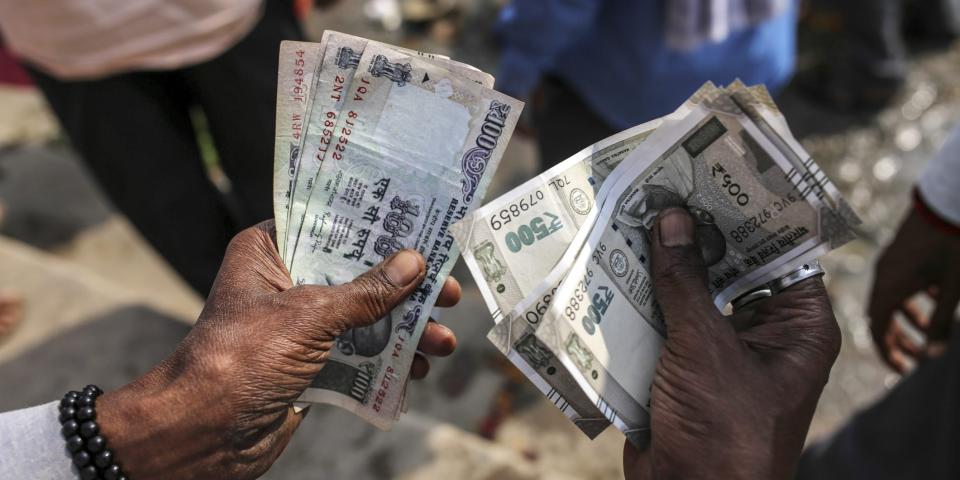 A man counts Indian rupee banknotes in Varanasi, Uttar Pradesh, India.