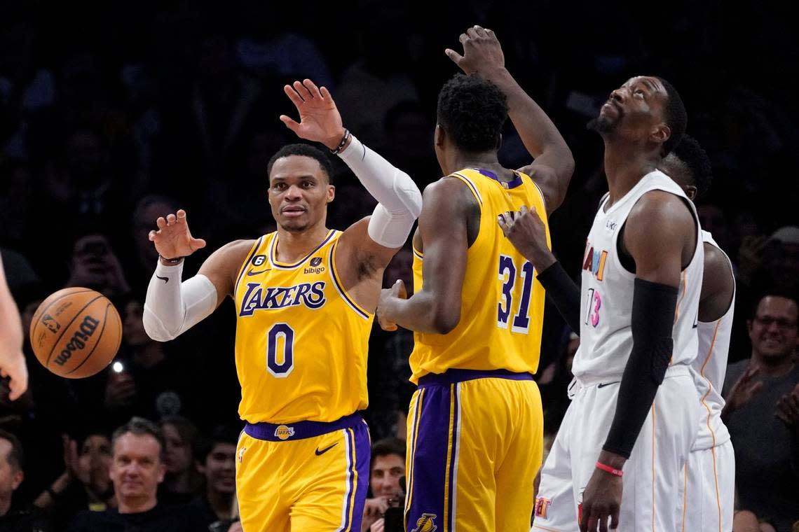 Los Angeles Lakers guard Russell Westbrook, left, celebrates with center Thomas Bryant, center, after scoring as Miami Heat center Bam Adebayo stands by during the second half of an NBA basketball game Wednesday, Jan. 4, 2023, in Los Angeles.